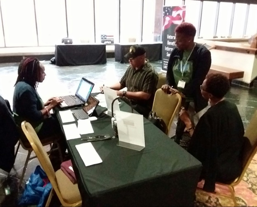 Co-Founder Dionne Archibald overseeing registration processes during a Veteran Benefits Information Seminar.